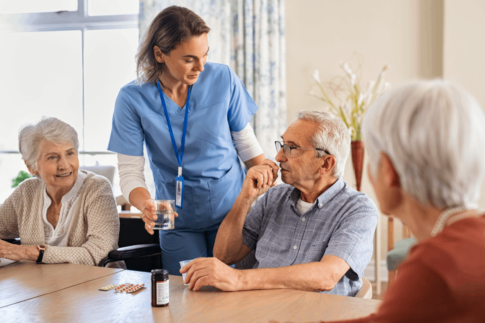 Nurse with elderly people around her