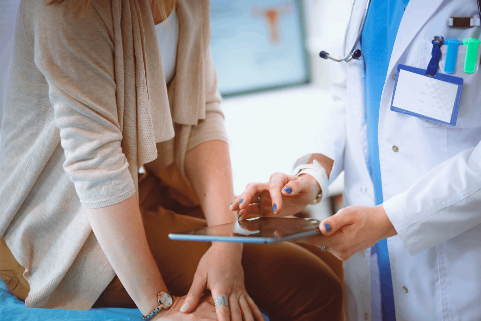 Doctor working with patient on iPad