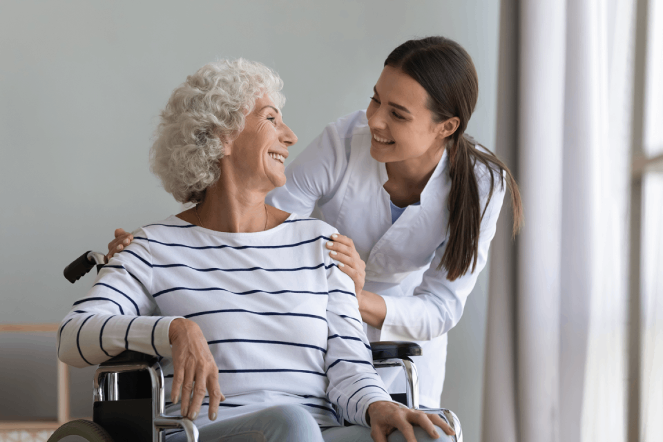 Nurse helping elderly woman